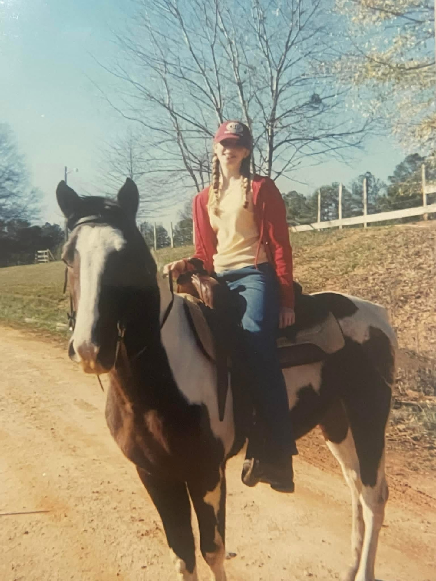 A thirteen-year-old Aubree riding Wrangler down a dirt road not long after she trained him